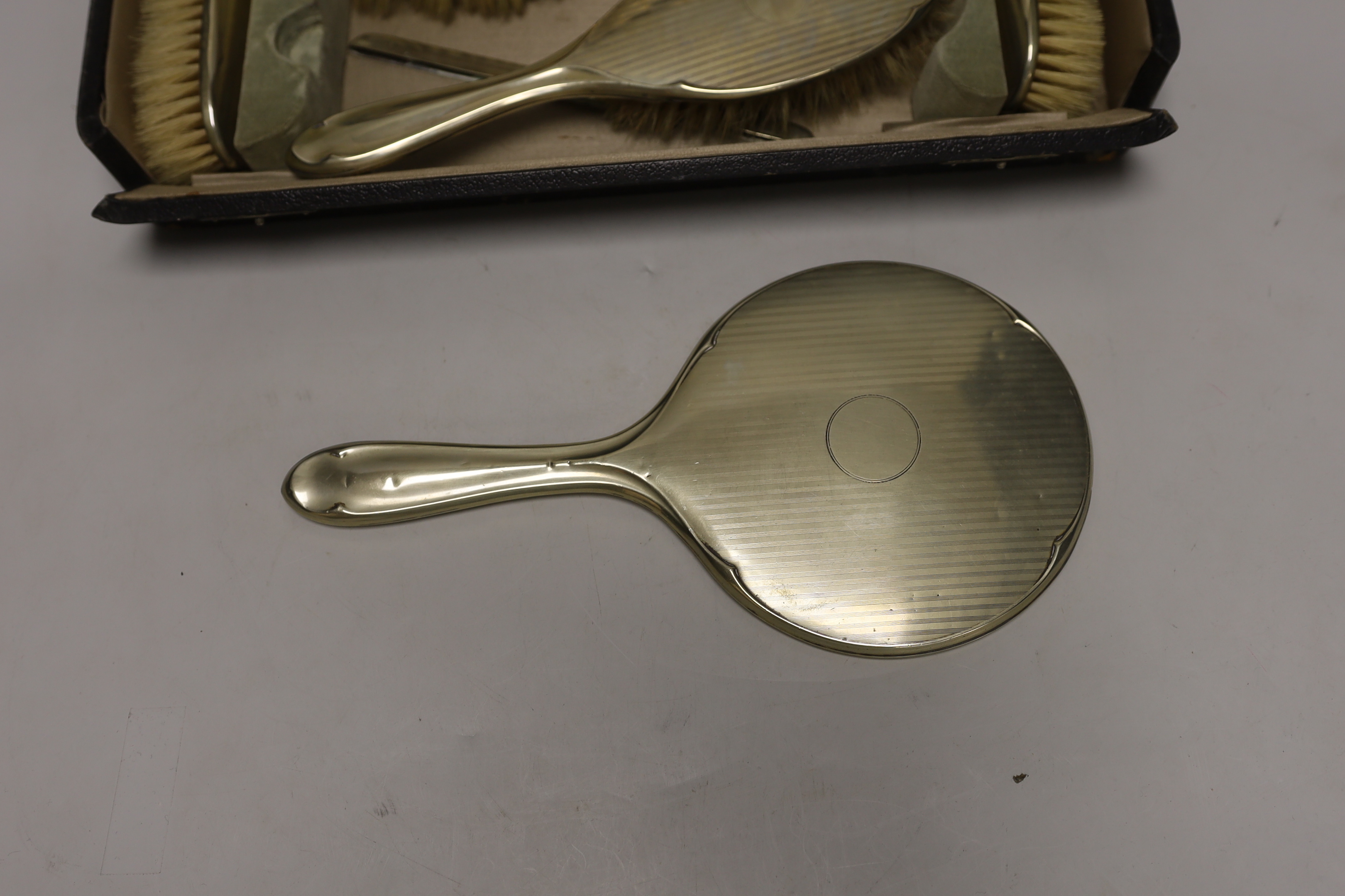 A cased 1930's six piece plated mirror and brush set.